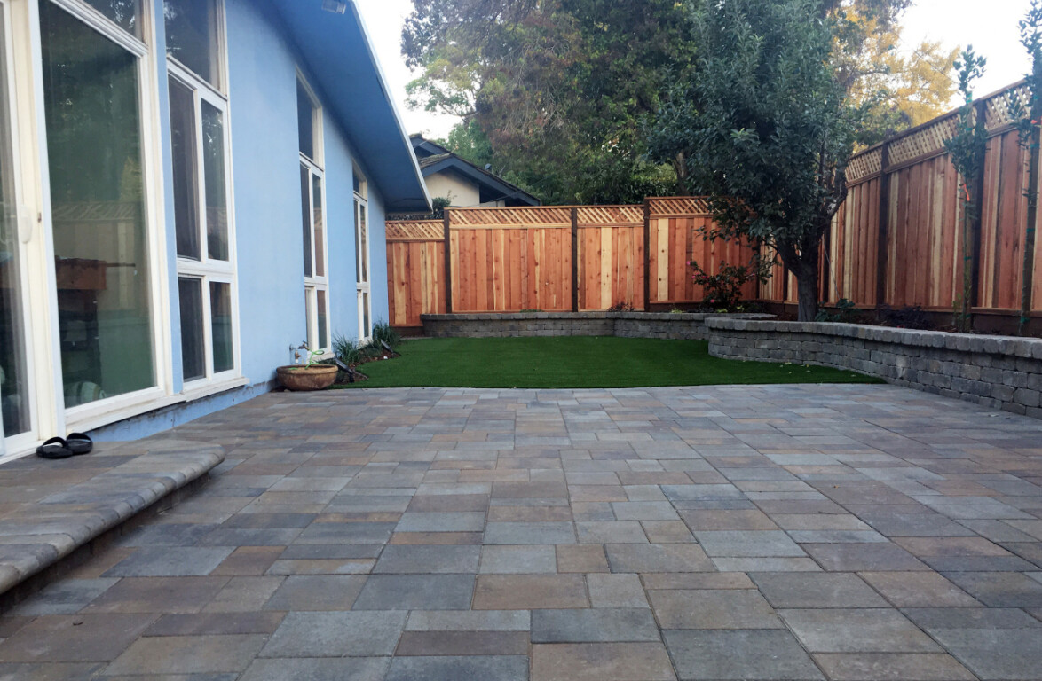 Beautiful decorative concrete patio with pavers in Seguin backyard